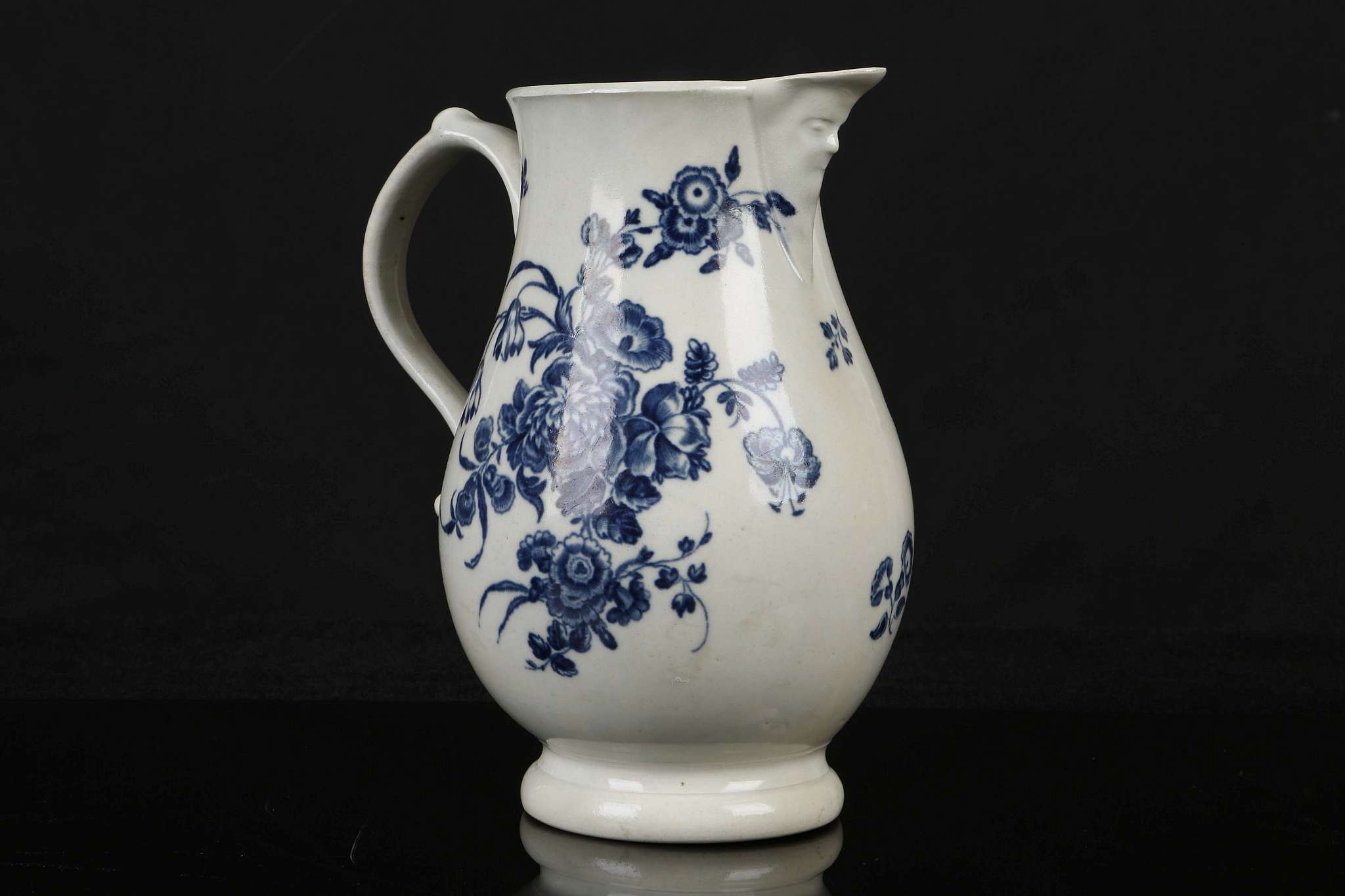 A WORCESTER MASK JUG, circa 1770, of baluster form printed in blue with the 'Bouquets' pattern (18cm