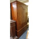 A contemporary yew wood wardrobe above four drawers