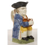 A PRATT-TYPE TOBY JUG, circa 1810, of Traditional form, modelled seated with a foaming jug resting