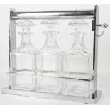 AN ART DECO CHROME PLATED AND GLASS TANTALUS, circa 1930, in the manner of Jacques Adnet, the