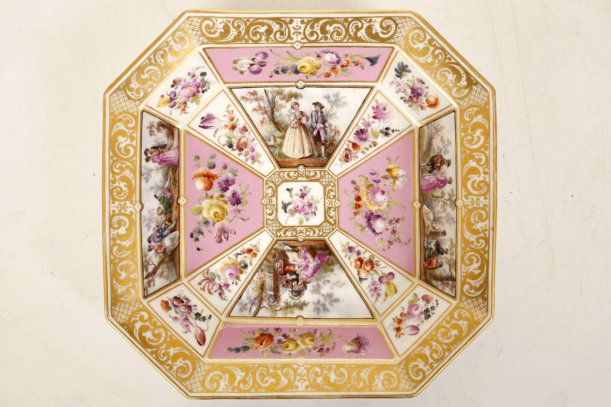 A GOOD BERLIN DISH, early 19th century, of octagonal shape, finely painted with panels of courting