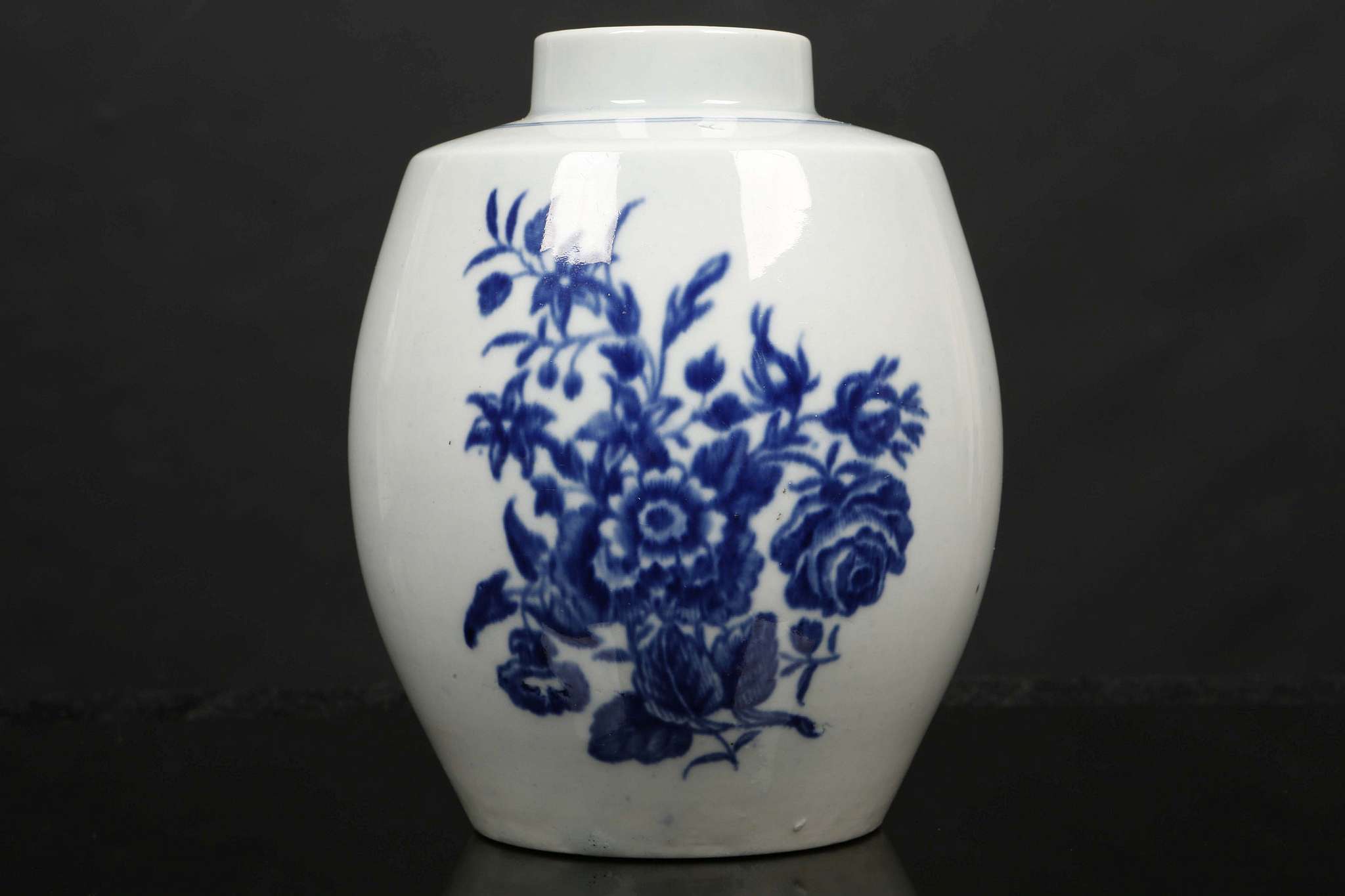 A WORCESTER TEA CANISTER, circa 1770, of barrel form, printed in blue with the 'Three Flowers'