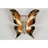 An 18ct gold butterfly brooch, with diamond set body and enamelled wings