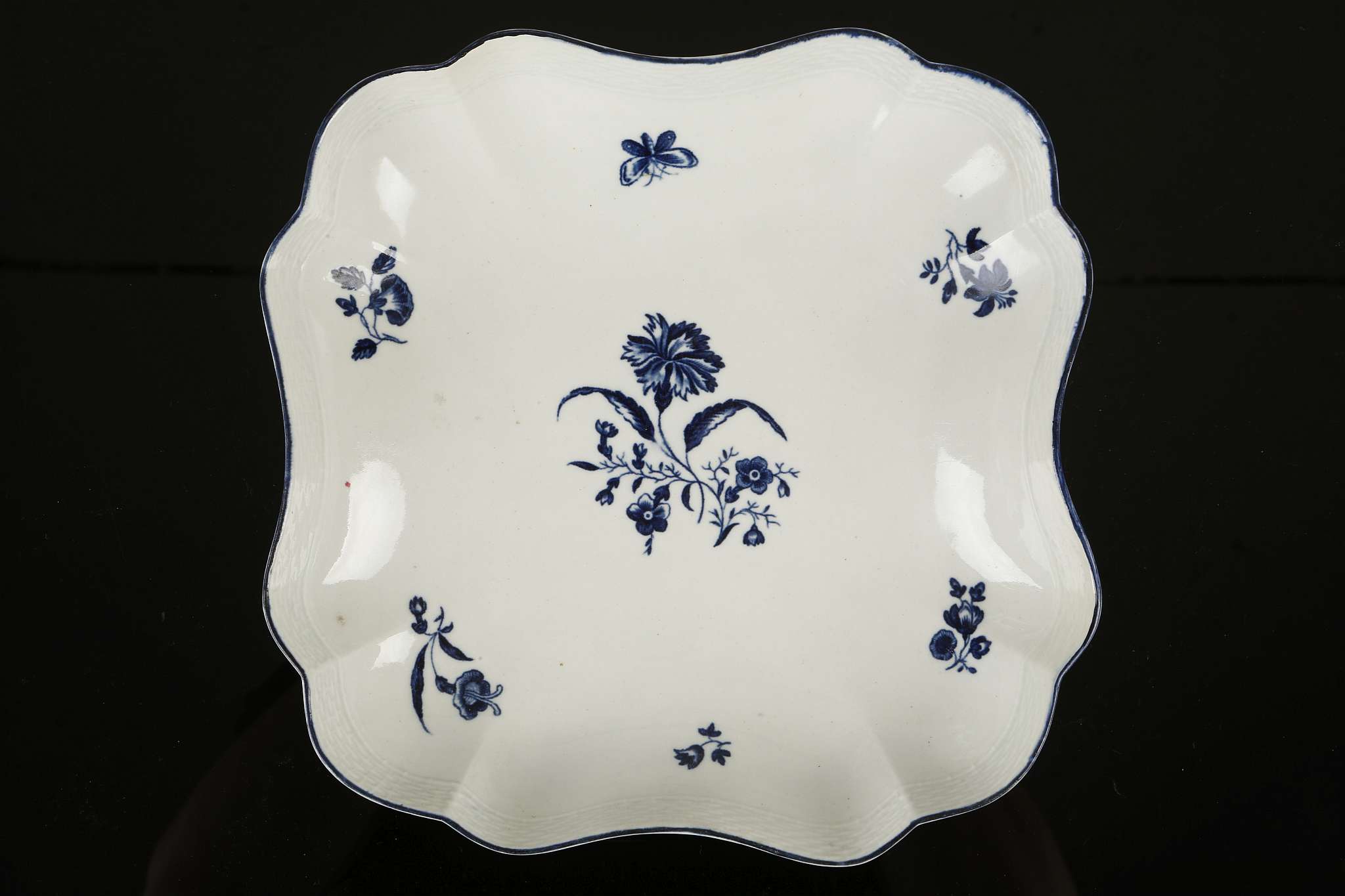 A WORCESTER DESSERT DISH, circa 1770, of unusual lobed square shape, printed in blue with the '