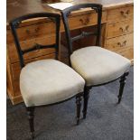 A set of four ebonised dining chairs, late Victorian, floral carving to back, tapering reeded legs