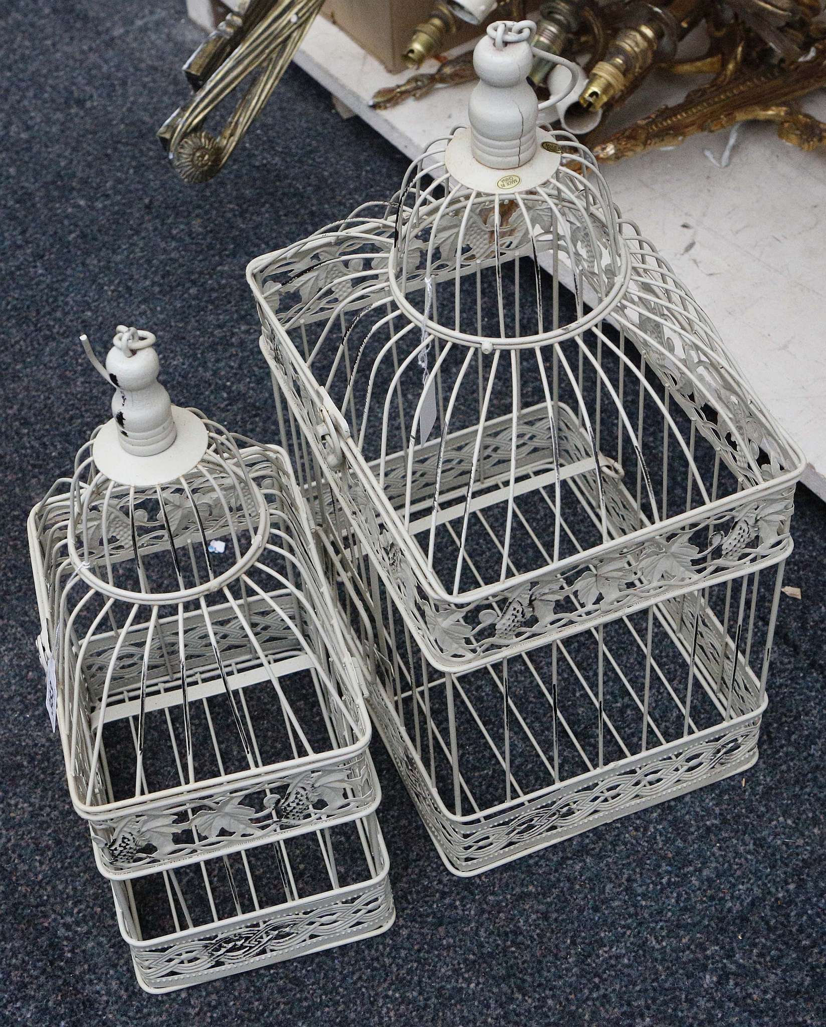 Two cream painted bird cages