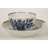 A WORCESTER TEABOWL AND SAUCER, circa 1770, printed in blue with the 'Three Flowers' pattern (the