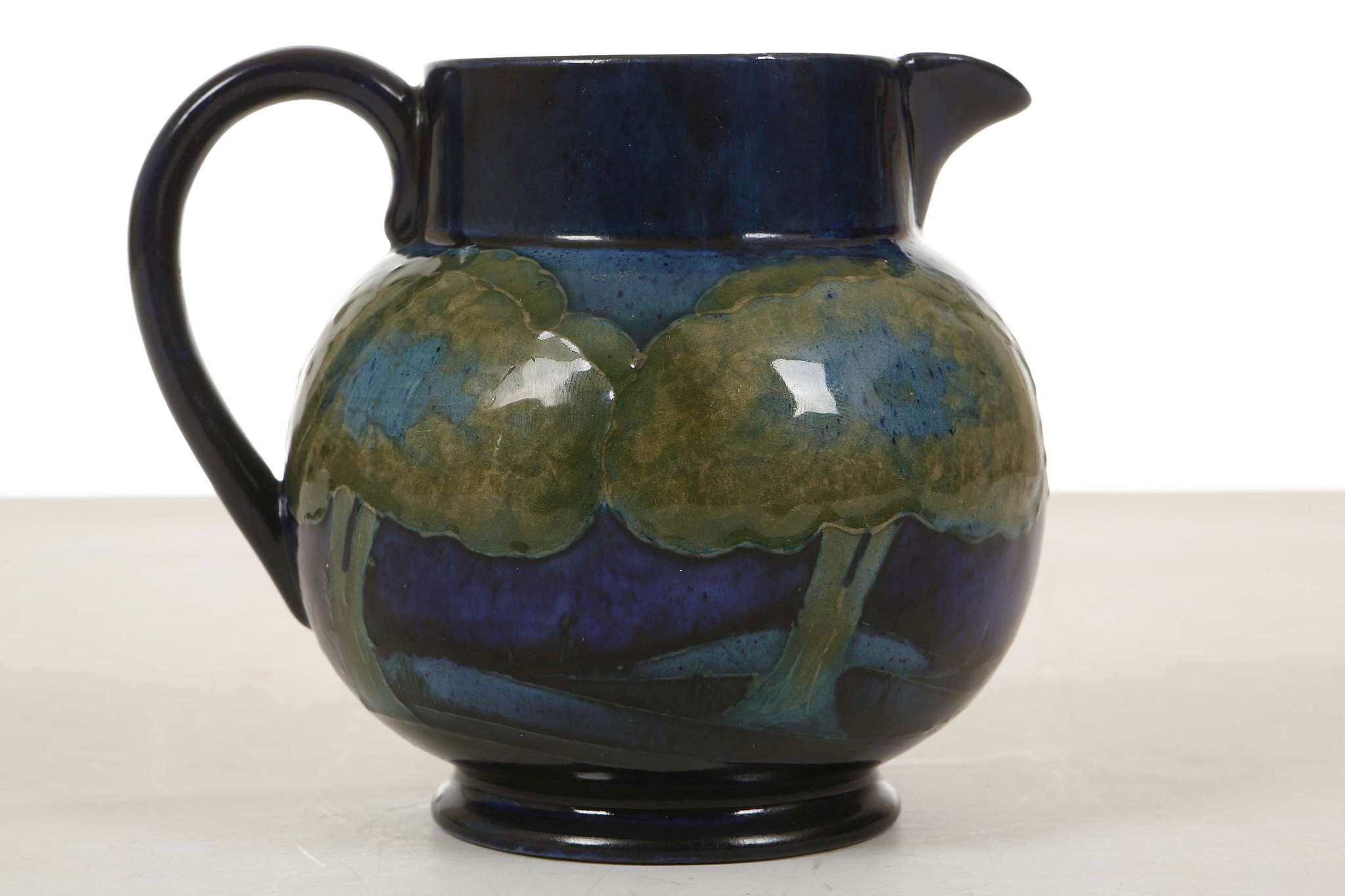 A WILLIAM MOORCROFT 'MOONLIT BLUE' JUG, circa 1925, the body painted with a continuous frieze of - Image 2 of 4