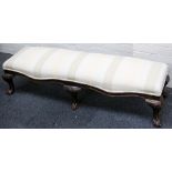 A 19th Century, possibly Irish, mahogany serpentine foot stool, with recent stripe upholstery, and