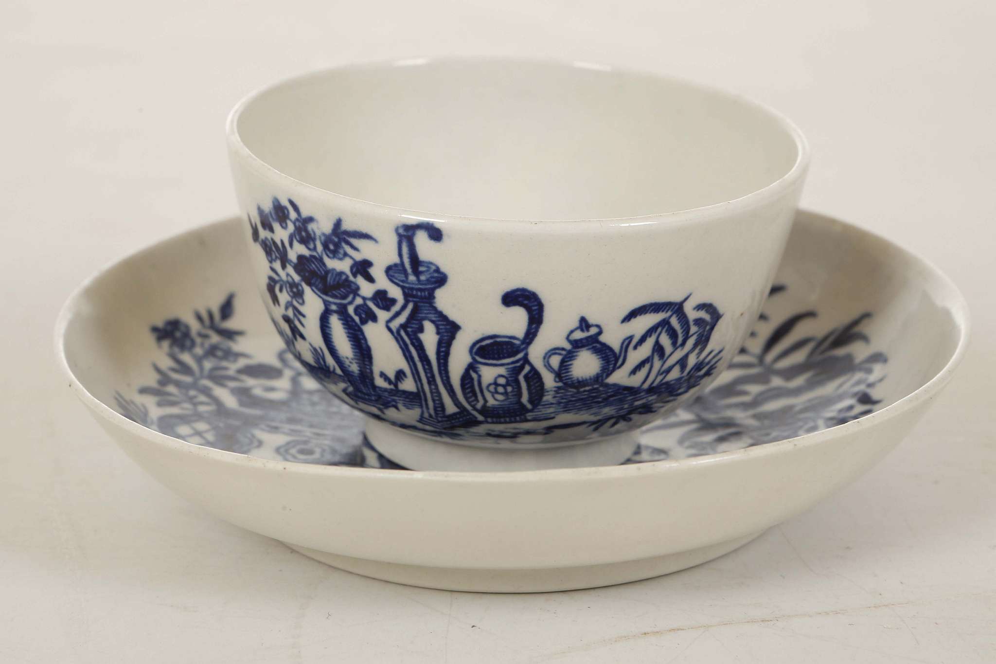 A WORCESTER TEABOWL AND SAUCER, circa 1780, decorated in blue with the 'Mother and Child' pattern,