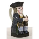 A STAFFORDSHIRE TOBY JUG, circa 1830-40, of Ordinary type, modelled seated with a foaming jug