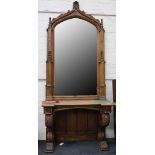 A pair of large Victorian Gothic oak consul tables, each with a large arched mirror, approx 340cm