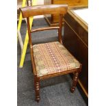 A set of six early 19th Century mahogany bar back dining chairs, with drop-in seats, and raised on
