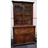 A late Georgian mahogany secretaire bookcase, the glazed upper section is on a cabinet base, with