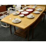 A large American 1950's dining table, cherry wood with three extension leaves.