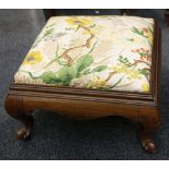 A 19th Century button-back easy chair, turned legs and a stool on ball and claw feet, later matching