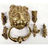 A vintage brass iron mask door knocker 21cm high, and 5 small knockers; kangaroo, acorn, clown,