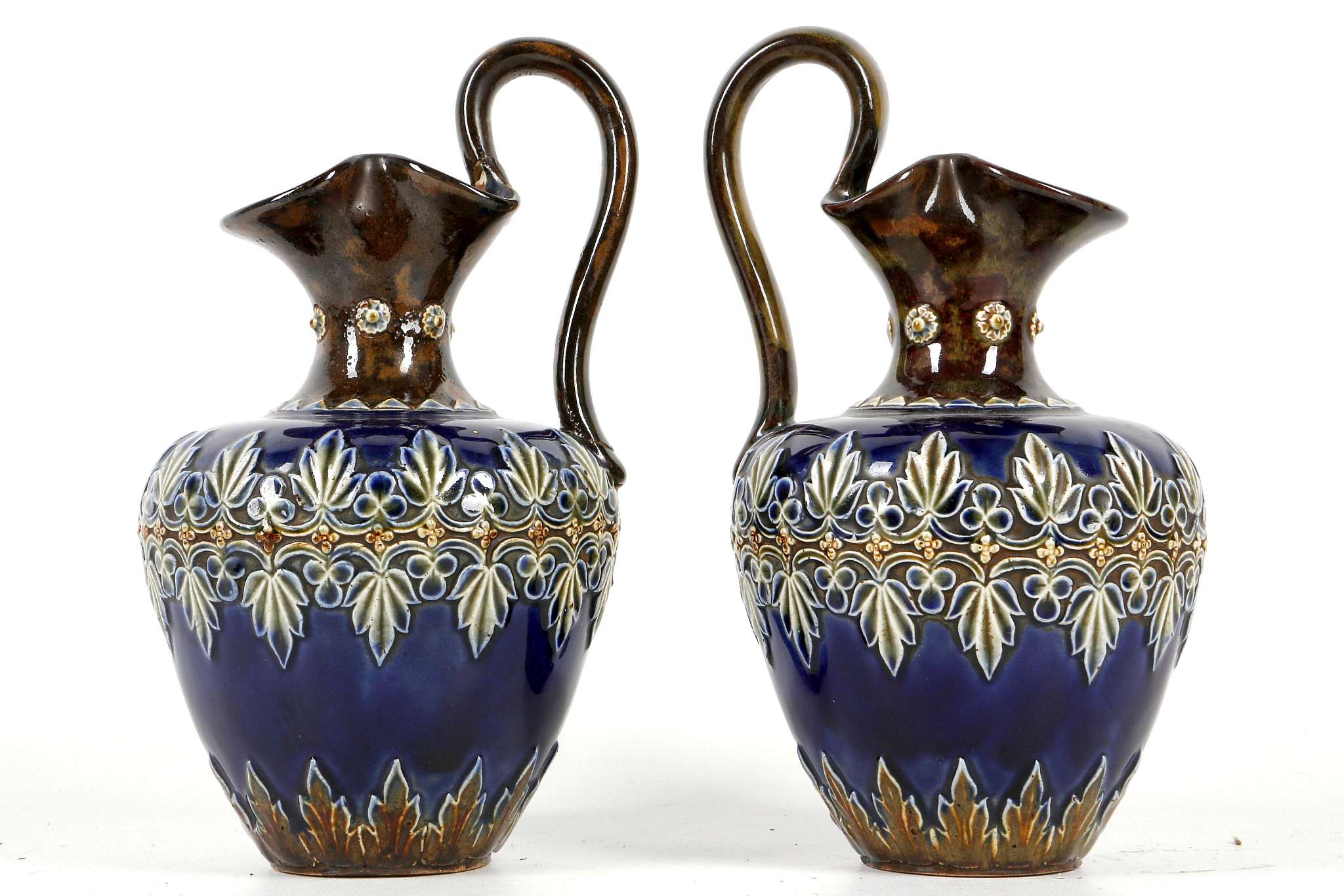 A pair of Royal Doulton stoneware ewers