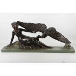 A large Art Deco style bronzed plaster figure of a recumbent lady with an eagle, 78cm wide, together