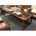 A 19th Century mahogany draw leaf extending dining table, with three spare leaves, raised on