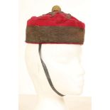 A 19th Century Officer's pill box hat, gilt braid pommel, claret with black band, Capt. Nolan hand