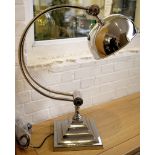 A large chrome study lamp with an adjustable dome frame