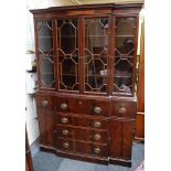 A Georgian style mahogany break front bookcase on a cabinet base with secretaire drawer over four