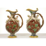A PAIR OF MINTON MAJOLICA EWERS BY HUGHES PROTAT,