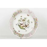 A Herend porcelain plate, with painted bird and insect decoration, with pierced and flower frieze,