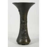 A Japanese bronze vase, decorated with a man playing bubbles, 25cm high
