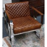 A polished bar steel and leather open armchair