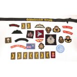 Cloth shoulder titles, bullion badges, sabretache bullion badges and other military badges