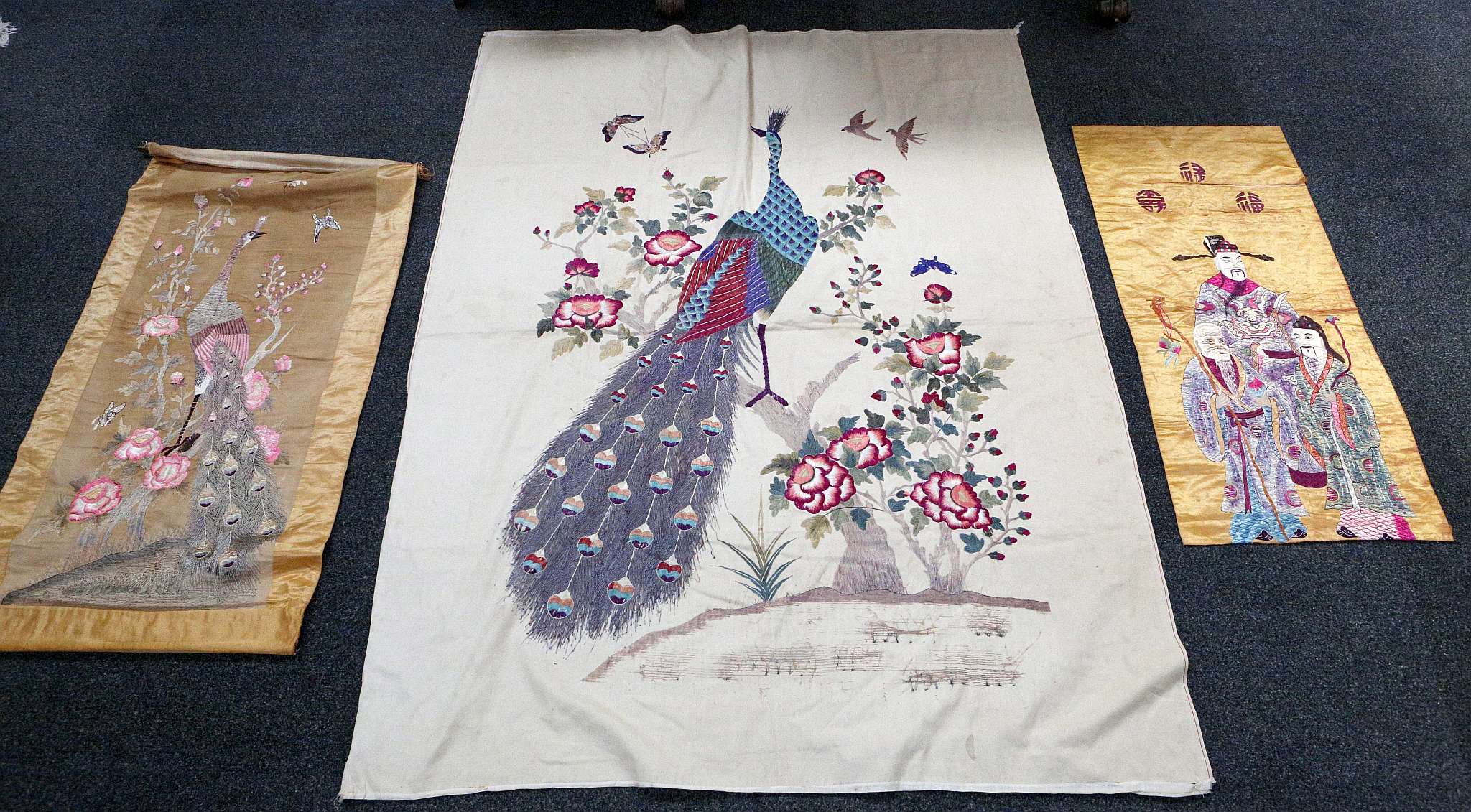An early 20th Century Chinese silk embroidered panel with peacock surrounded by peonies, 185 x