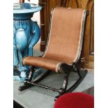 A 19th Century child's 'S' shaped, ebonised rocking chair, with brass patena and beading