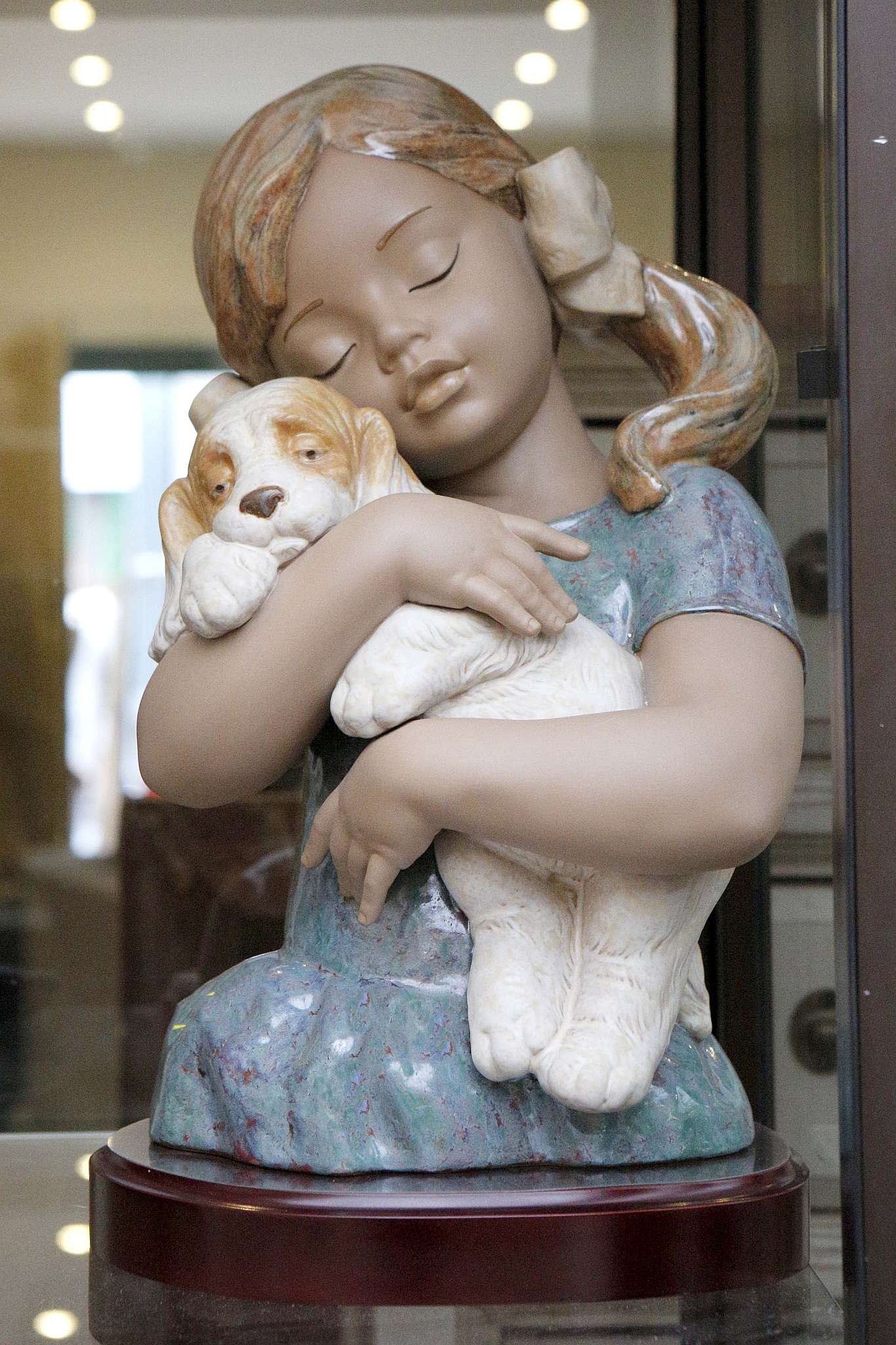 A large Lladro ceramic figure of a girl holding a