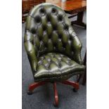 A green leather button back desk chair