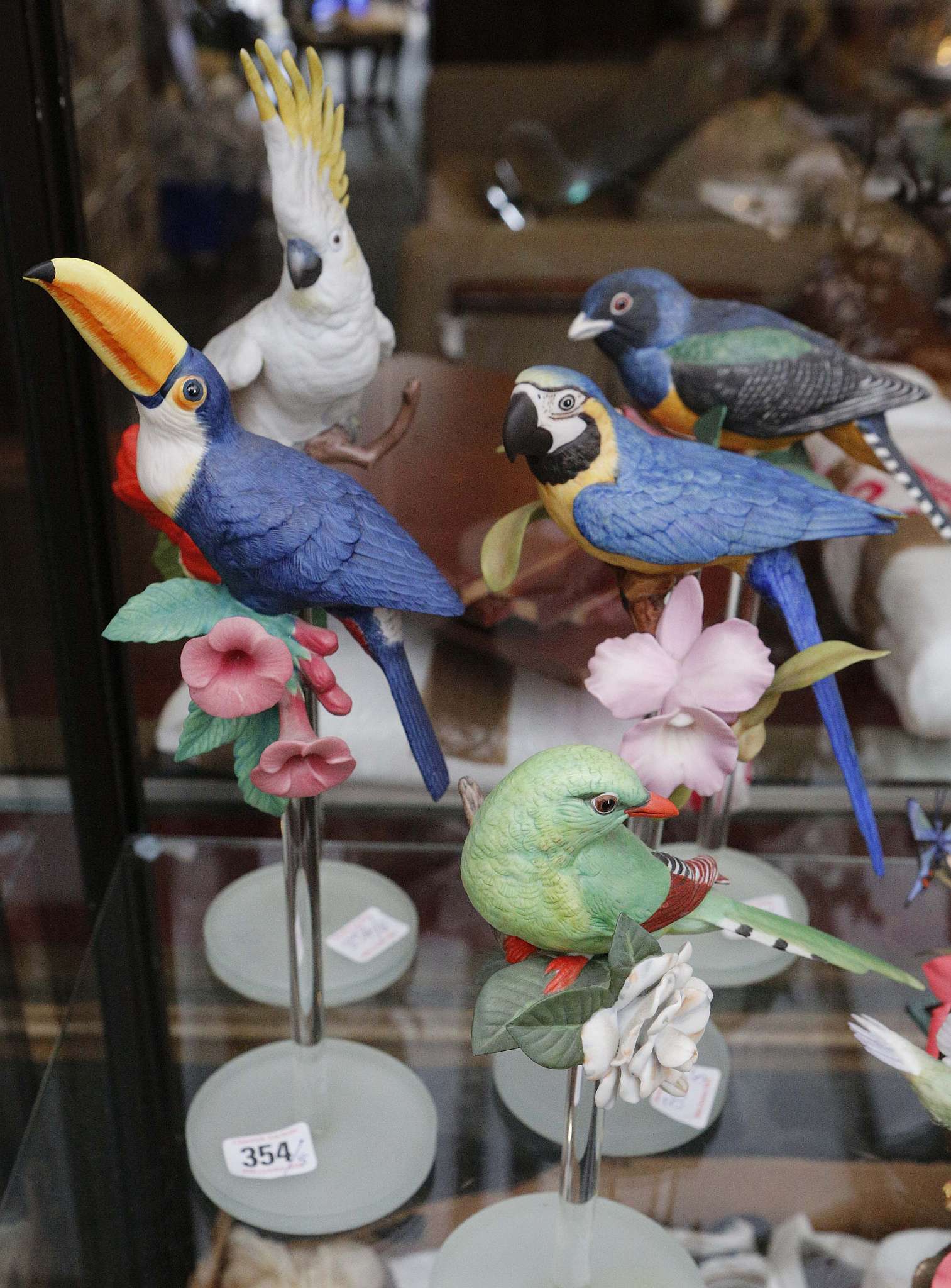 Five well modelled polychrome glazed models of colourful exotic birds