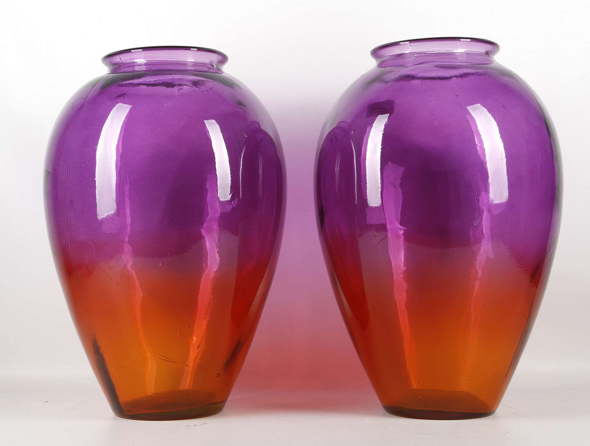 A pair of large ovoid glass vases, shading from amethyst to amber, 43cm high (2)