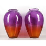 A pair of large ovoid glass vases, shading from amethyst to amber, 43cm high (2)
