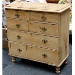 An early 20th Century striped pine chest of 2 over 3 drawers, brass handles, turned feet