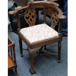 A mahogany corner chair with pierced back rest, over a drop in seat, raised on carved cabriole legs