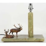 An Art Deco period onyx table lamp with cold painted bronze stags
