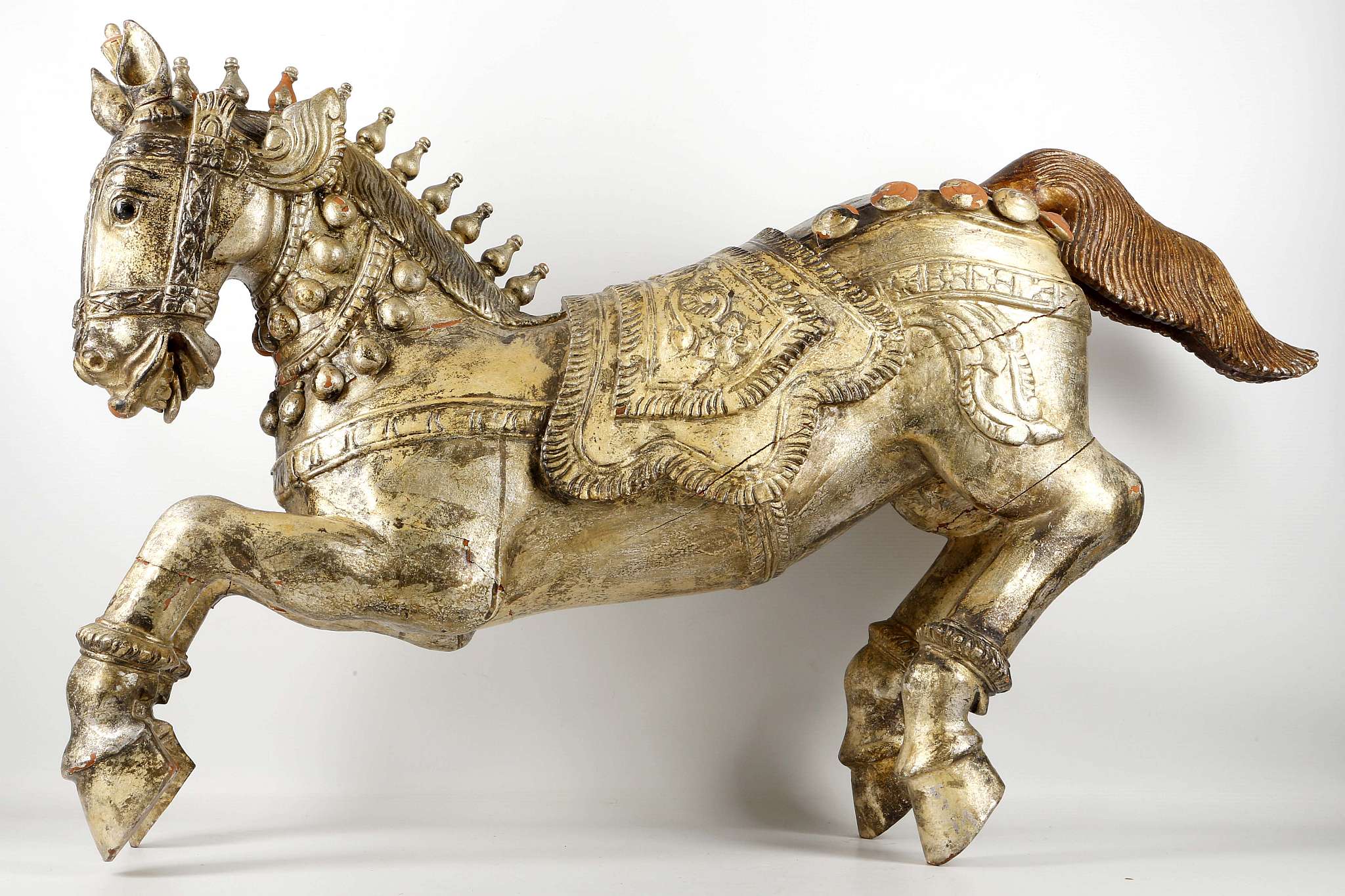 A pair of antique Indian carved and giltwood stallions, 36cm long (2)