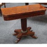 A Georgian mahogany fold over card table on reeded pedestal with brass lotus base, raised on a