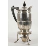 An Edwardian hallmarked silver coffee pot, on a silver three legged stand and burner, London 1906 by