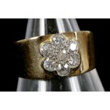 An 18ct band ring with applied diamond set floral lustre