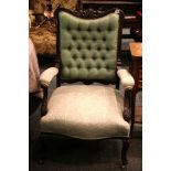 A pair of his and hers armchairs, mahogany frame, with leaf carving, button back, padded arms,