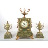 A French onyx mantle clock and garniture, brass fittings withurn finial and acanthus handles, Japy