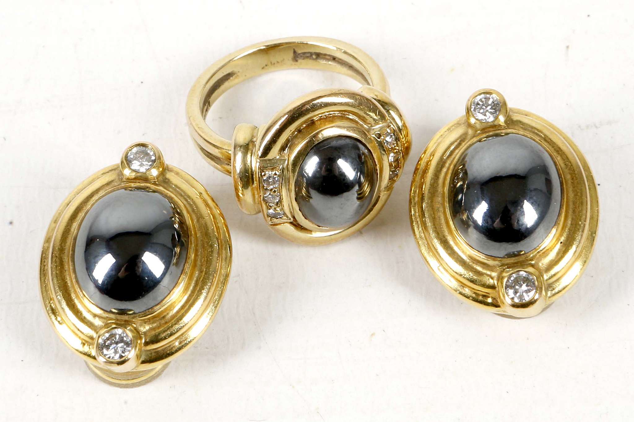 A pair of gold and haematite earrings with clasp-backs, together with a matching ring, marked 'D &