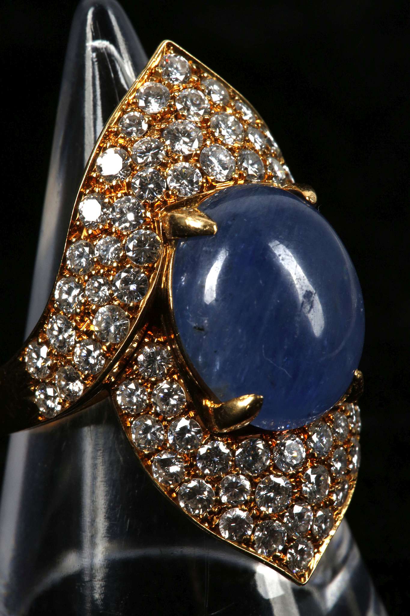 An 18ct gold, cabouchon sapphire and diamond set cocktail ring